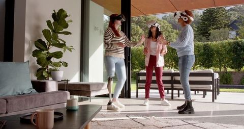 Group of diverse women enjoying virtual reality indoors