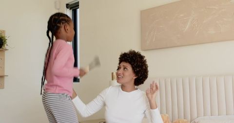 Mother and Daughter Bond in Bedroom with Morning Playtime Fun