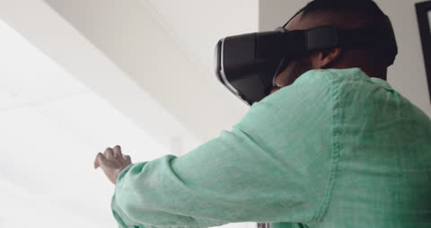 Man Engaged in Virtual Reality Experience at Home