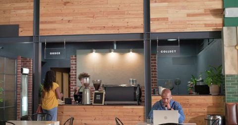 African american customers working and ordering in cozy industrial coffeehouse interior