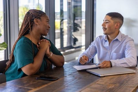 Diverse Coworkers Discussing Documents at Office Conference Table
