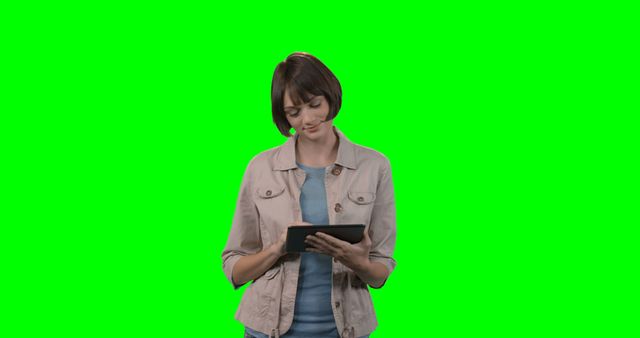 This image of a woman using a tablet on a green screen background can be used for various technology and business concepts. Great for creating promotional materials for tech products, online applications, or digital media. Ideal for use in presentations, websites, or marketing materials to illustrate modern technology usage and online connectivity.