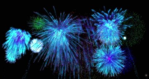 Dazzling blue and cyan fireworks display at night