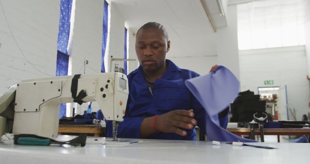 Tailor working on sewing machine in modern atelier workshop - Download Free Stock Images Pikwizard.com