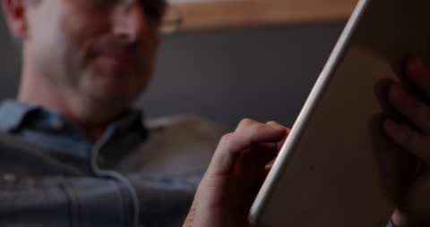 Focused Professional Using Tablet in Creative Office Setting