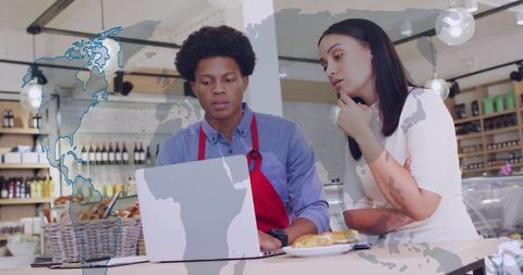 Business Team Analyzing Financial Data in Trendy Coffee Shop