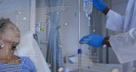 Clinician adjusting iv drip while patient resting in hospital bed with blue gown