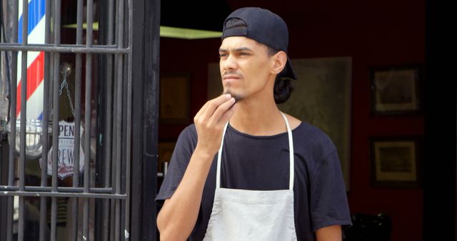 Barber Wearing Apron Standing Outside Shop Contemplating - Download Free Stock Images Pikwizard.com