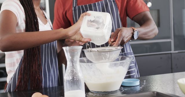 Couple baking together sifting flour into mixing bowl - Download Free Stock Images Pikwizard.com