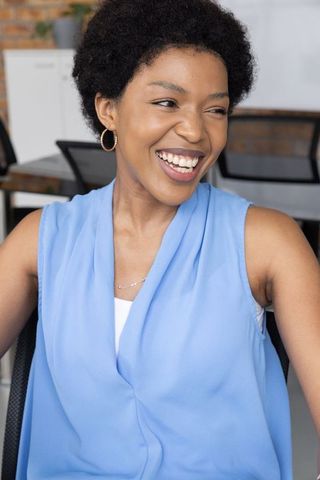 Smiling african american businesswoman in modern workspace