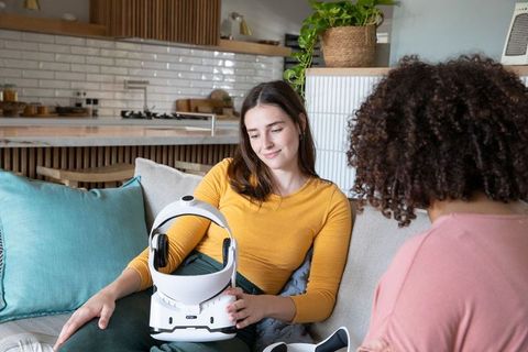 Diverse Friends Testing VR Helmet in Modern Home Interior