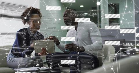 Business colleagues reviewing tablet with digital data overlay discussing analytics teamwork
