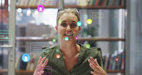 Caucasian businesswoman in virtual meeting with media icons floating