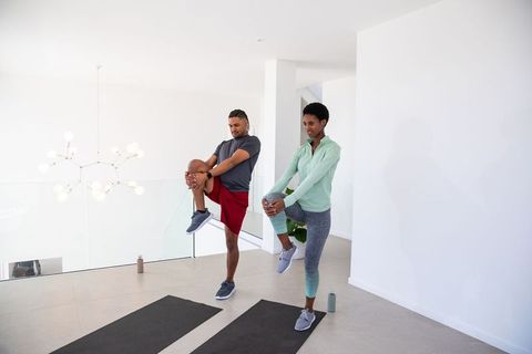 Diverse Friends Stretching in Modern Home Gym for Wellness and Flexibility