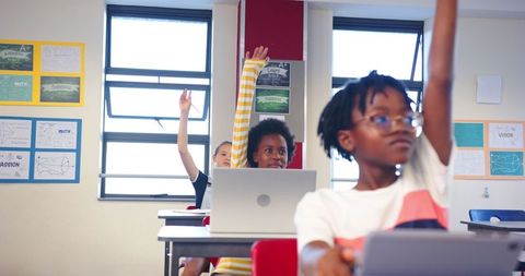 Diverse Students Using Laptops in Classroom Learning Environment