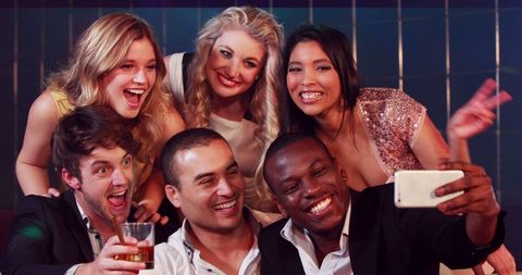 Diverse Friends Smiling and Posing for a Celebration Selfie