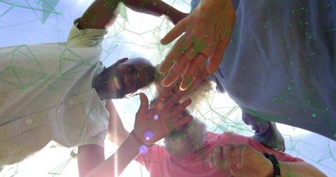 Reaching Up Together Sunlit Team Stacking Hands Outdoors for Collaboration and Unity Trio