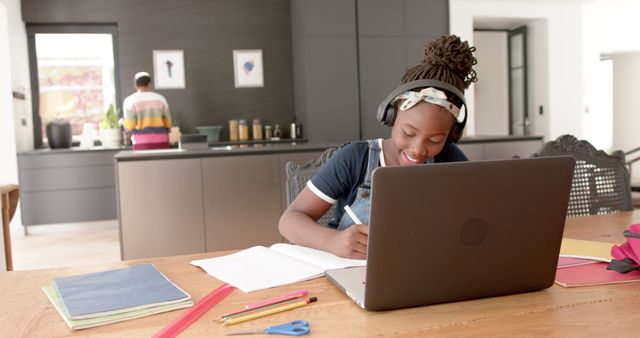 Young Girl Wears Headphones While Studying at Home with Laptop - Download Free Stock Images Pikwizard.com