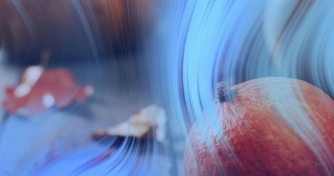 Autumn Pumpkin Resting on Wooden Table with Painterly Blue Motion Streaks