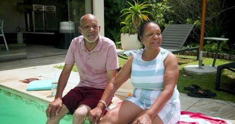 Senior African American Couple Relaxing Poolside with Joy