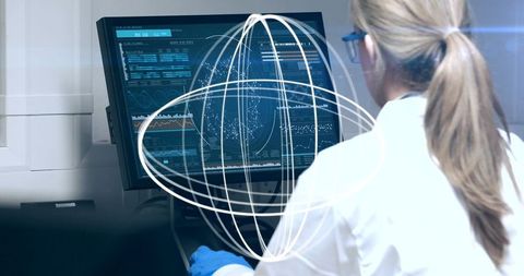 Female Scientist Analyzing Data on Computer Screen with Virtual Graphics