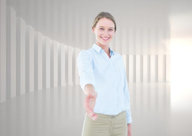 Digital composition of smiling businesswoman offering her hand for a handshake against white grey background