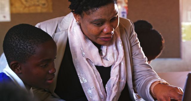 Female Teacher Helping Students in Classroom - Download Free Stock Images Pikwizard.com