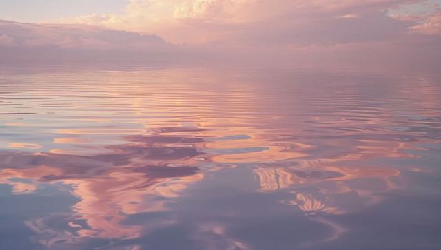 Calm seascape with pastel skies reflecting in tranquil waters