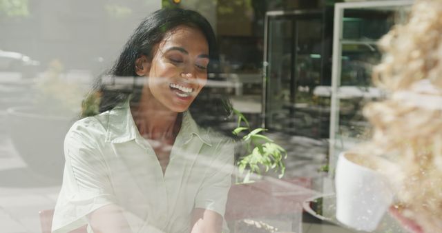 Friendly woman enjoying coffee in cafe, smiling through window - Download Free Stock Images Pikwizard.com