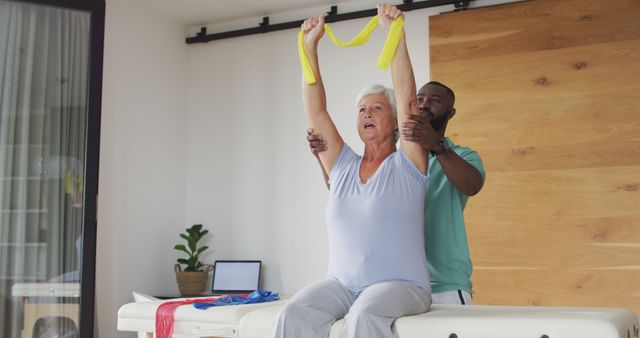 Image of happy caucasian senior woman exercising with african american male physiotherapist. seniors health and nursing home lifestyle concept digitally generated image.
