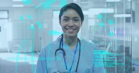 Smiling nurse wearing scrubs and stethoscope in hospital corridor with digital health holograms