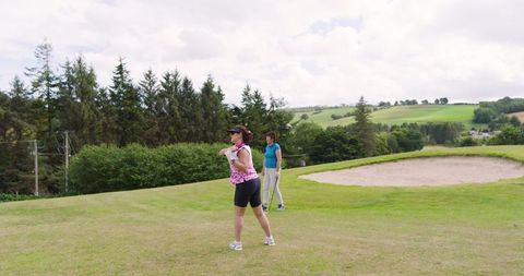 Female Golfing Duo Enjoying Weekend on Scenic Course