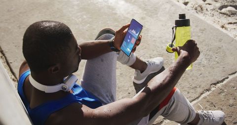 Sportsman Tracking Workout Statistics on Smartphone Outdoors - Download Free Stock Images Pikwizard.com