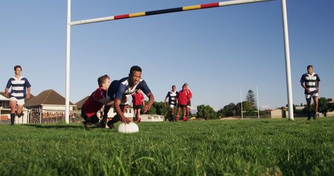 Youth Rugby Players Competing in Intense Match on Sunny Field