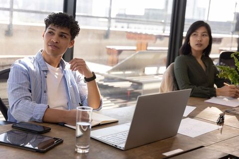 Diverse Team Engaged in Thoughtful Office Discussion