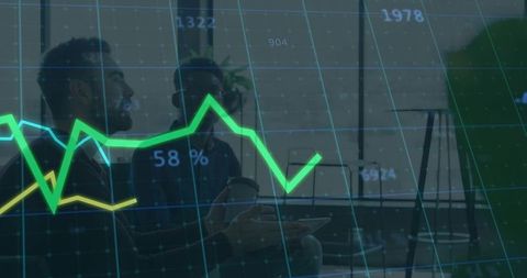 Two professionals analyzing financial charts with glowing data overlay in modern office