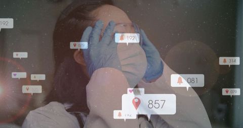 Korean doctor adjusting protective goggles and mask with AR notification overlay
