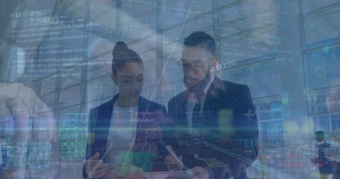 Diverse professionals analyzing financial digital data in modern office