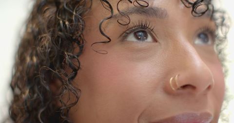 Elegant woman with charming nose ring in natural light close-up