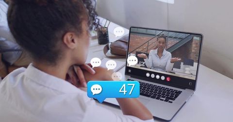 Video conference with 47 chat notifications, woman engaging on laptop, remote collaboration