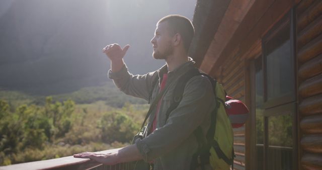 Male Hiker Enjoying Scenic View from Rustic Cabin Balcony - Download Free Stock Images Pikwizard.com