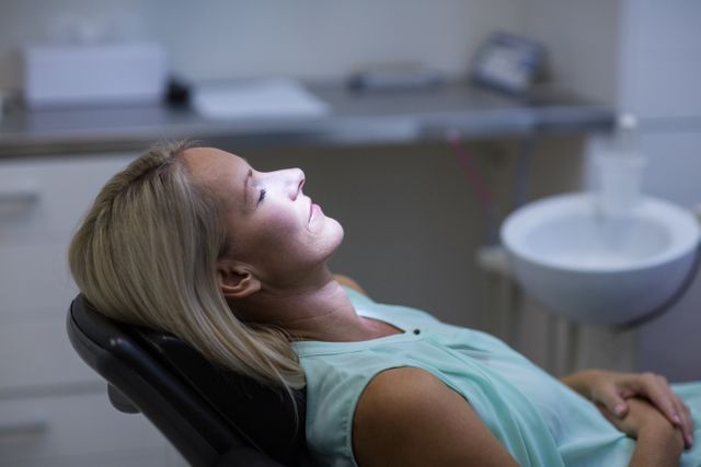 Woman relaxing on dentist chair in dental clinic