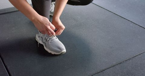 Woman Tying Shoelaces Preparing for Gym Workout - Download Free Stock Images Pikwizard.com