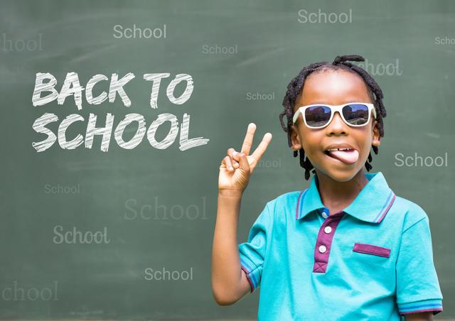 Digital composite image of schoolboy wearing sunglasses and gesturing with back to school text on chalkboard