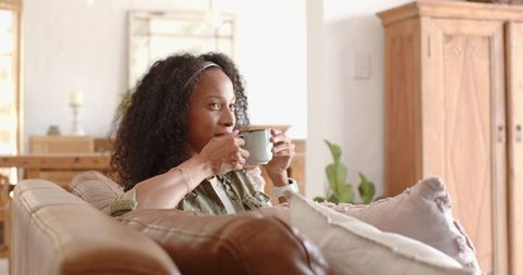 Woman Sipping from Mug in Cozy Modern Living Room