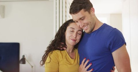 Happy Couple Embracing at Home in Warm Atmosphere