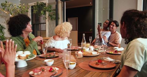 Happy Diverse Friends Enjoy Dinner Party on Outdoor Terrace