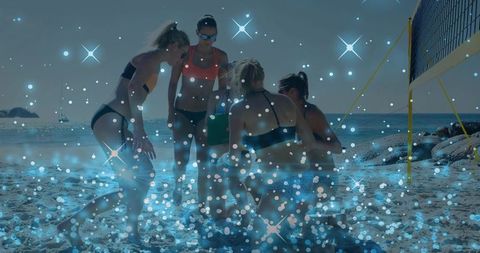Beach volleyball team huddling on island shore with blue bokeh sparkle overlay