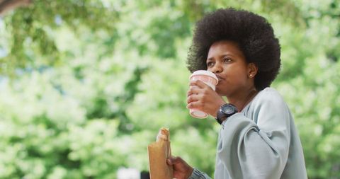 Urban Professional Enjoys Takeaway Snacks in City Park
