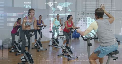 Coach leading indoor cycling class spinning workout with futuristic hud overlay